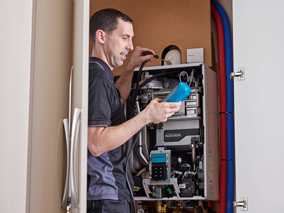 Installer servicing boiler
