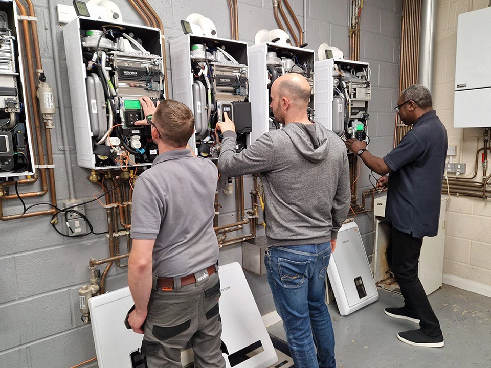 Gas engineers practicing installing gas boilers